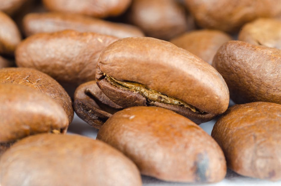 Close-up view of natural roasted coffee beans with a rich brown texture.